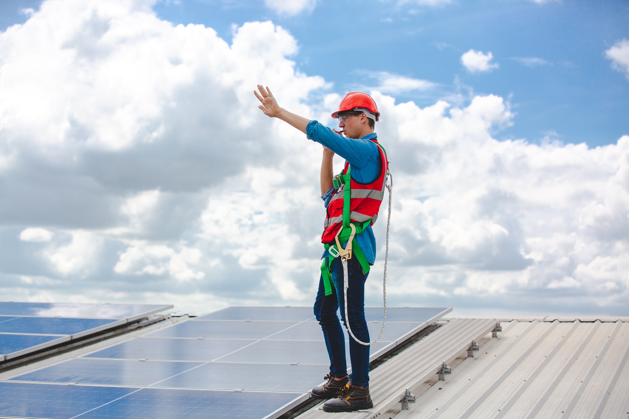 Professional technicians carrying photovoltaic solar moduls, Engineers installing on factory roof